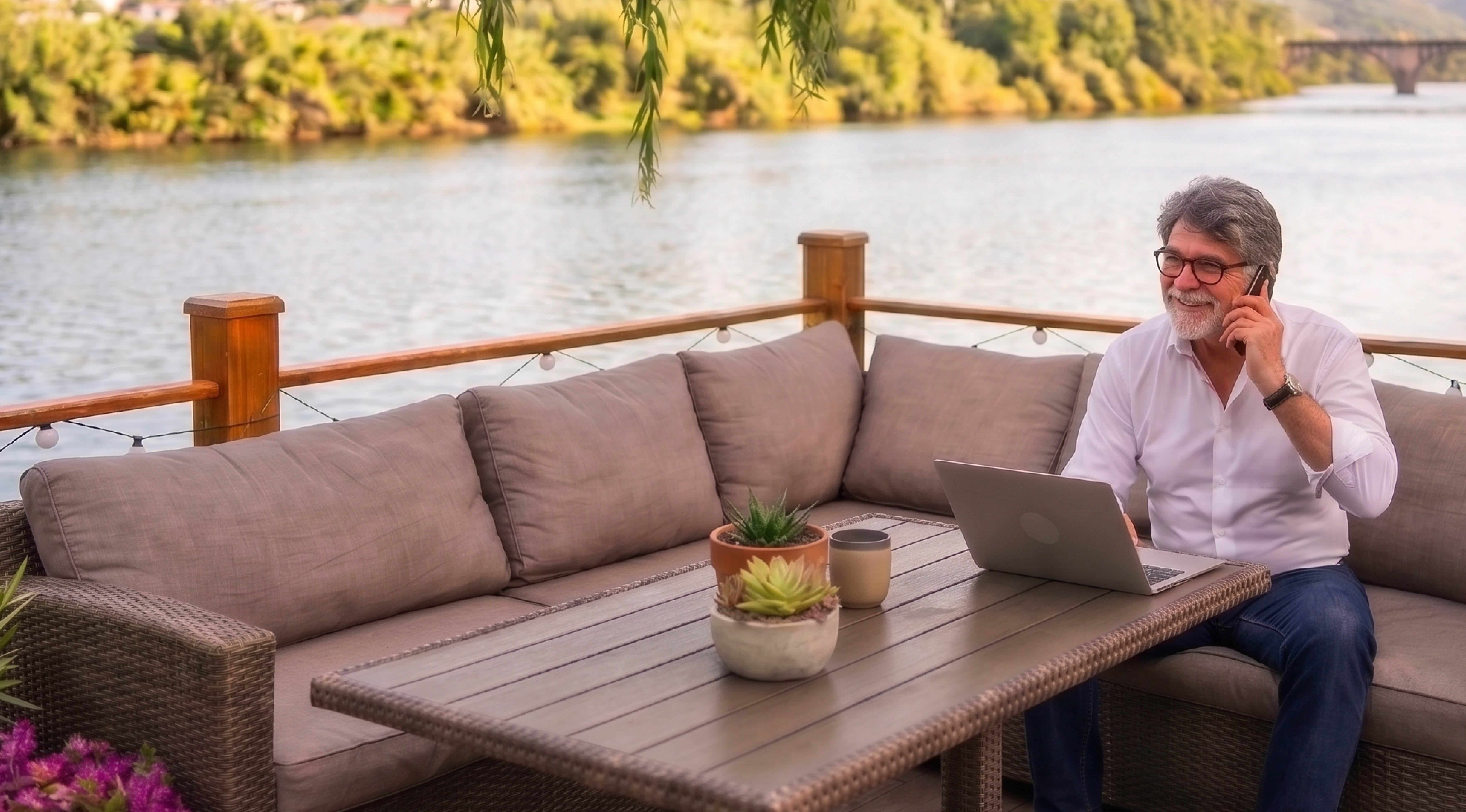 Man using a laptop outdoors with the message More support. Less Busywork.